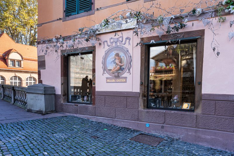 Une façade peinte de la Petite France, son médaillon et le pavé de la place